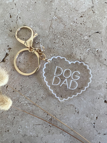 Keychain with 'DOG DAD' heart tag on a textured surface