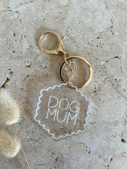 Keychain with 'DOG MUM' tag on a textured surface