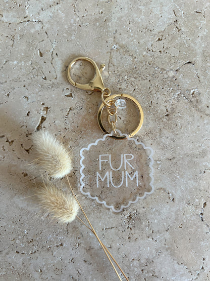 Keychain with 'FUR MUM' tag on textured surface
