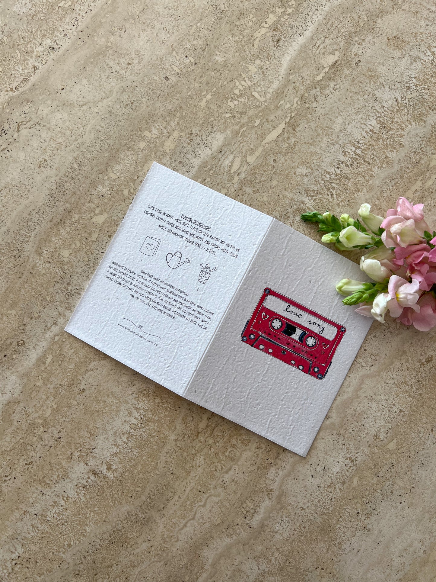 Open card with cassette tape "love song" illustration on a textured surface with flowers by Willow & Sage co