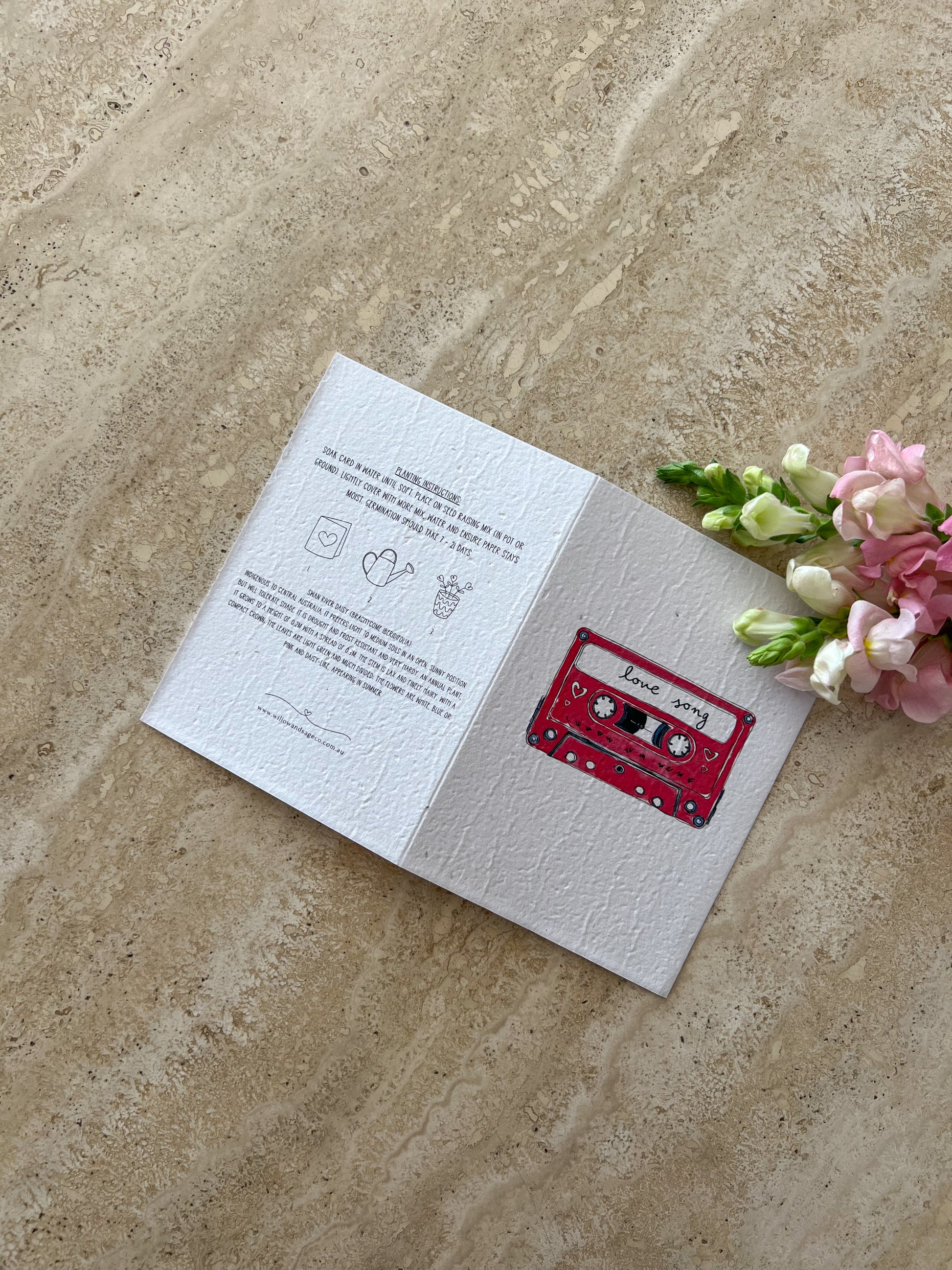 Open card with cassette tape "love song" illustration on a textured surface with flowers by Willow & Sage co