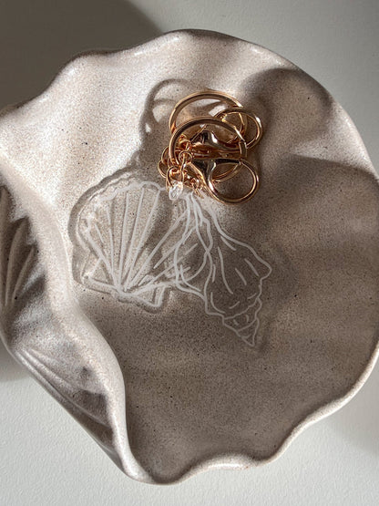 SEA SHELL KEYCHAIN BY WILLOW & SAGE CO PHOTOGRAPHED IN PALOMA STONE DISH BY BYREN HOME