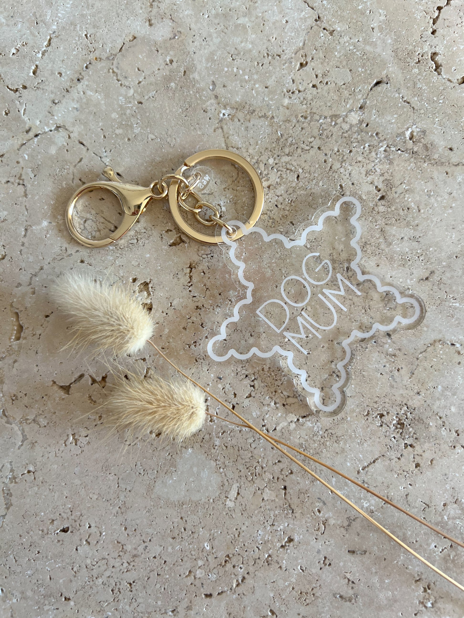 Keychain with 'Dog Mum' star charm on a textured surface
