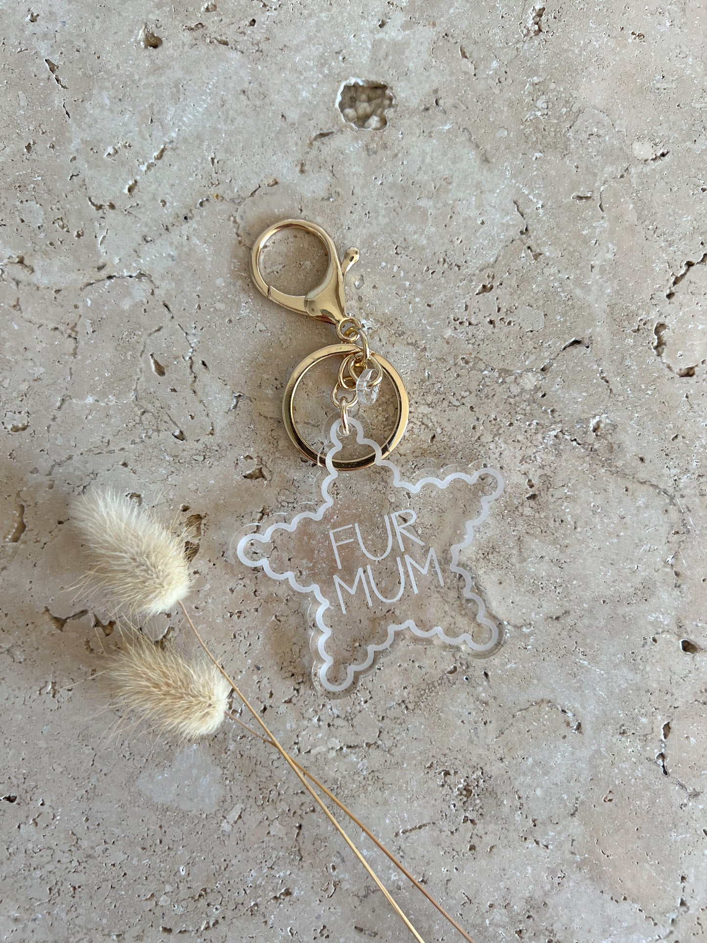 Keychain with 'Fur Mum' tag on a textured surface